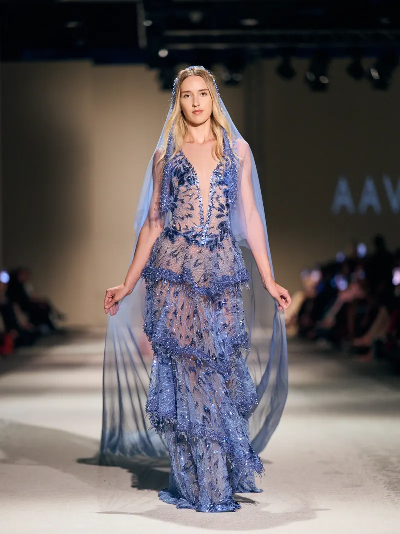 Full length runway shot of Lisa in the blue embellished AAVVA gown and veil