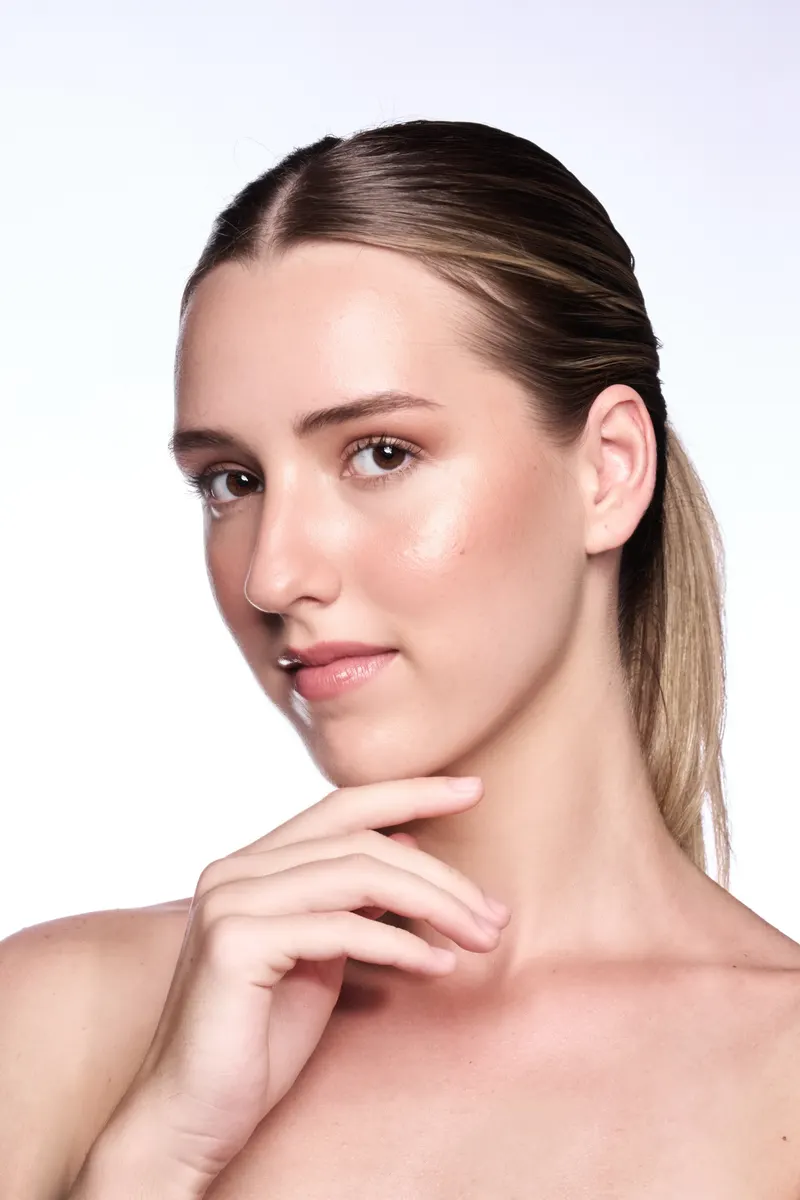 Beauty portrait of Lisa with slicked back hair and hand at her chin