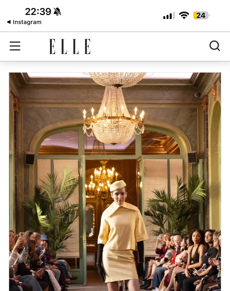 ELLE Instagram feature showing Lisa on a salon runway in a yellow suit