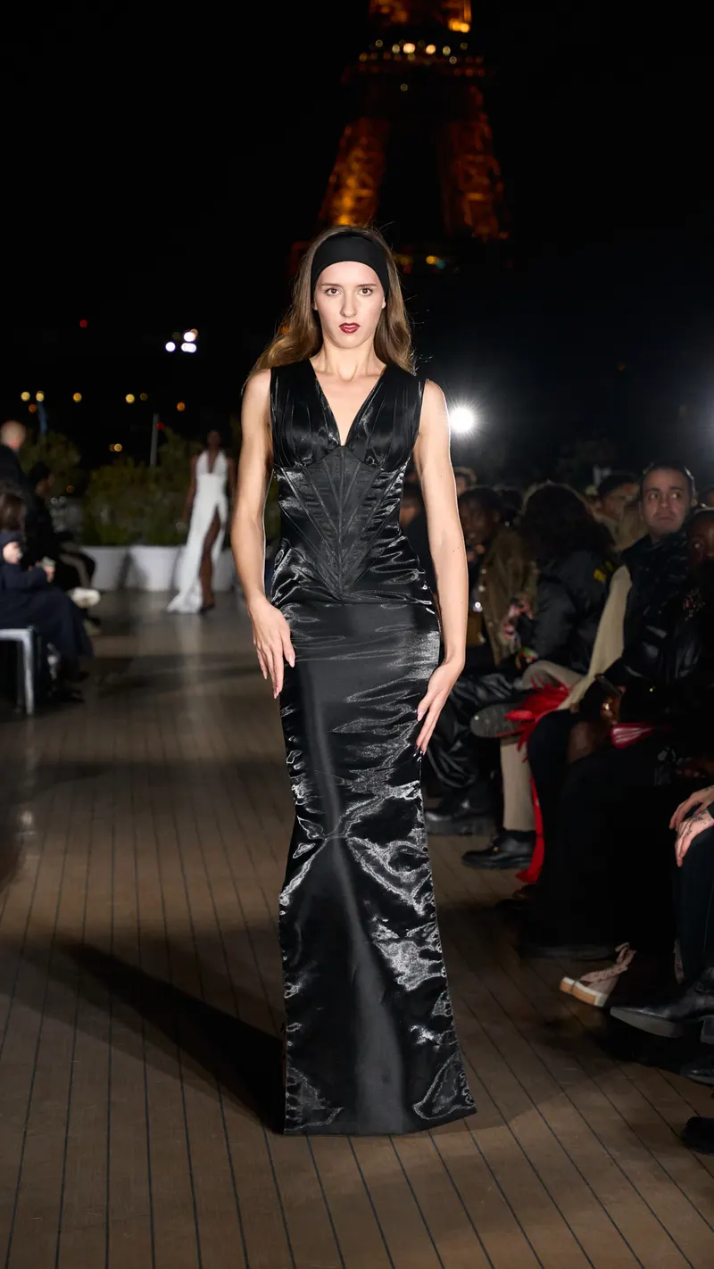 Lisa on an evening runway in Paris in a black satin top and skirt