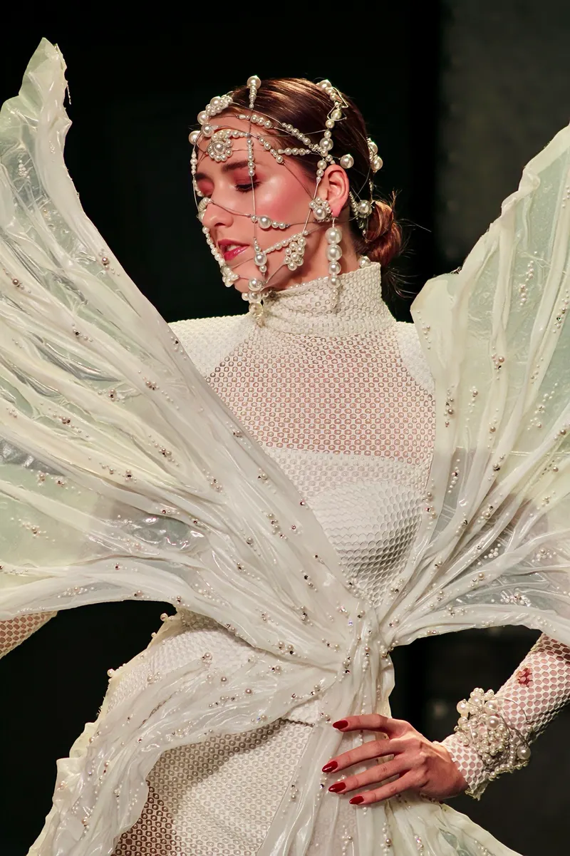Lisa in a sculpted white winged look with a pearl face piece